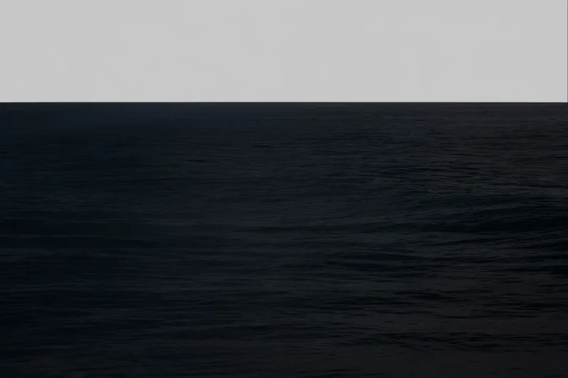 MXXII — seascape with a sharp horizon dividing light gray sky from deep dark ocean with visible wave texture, Santa Monica Bay. Medium format film by Alex Hoerner.