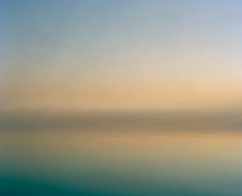Salton Sea Sunset — warm peach and turquoise color-field photograph of sunset over the Salton Sea, sky and water merging in bands of golden light. Medium format film by Alex Hoerner.