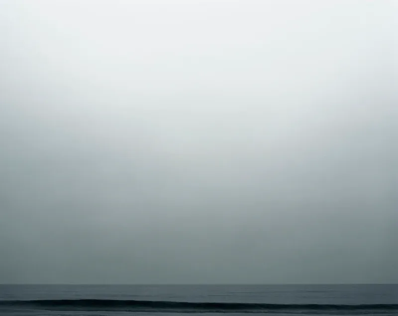 Untitled II — June Gloom seascape with cool gray sky and a defined dark wave line at the horizon, Santa Monica Bay. Medium format film by Alex Hoerner.
